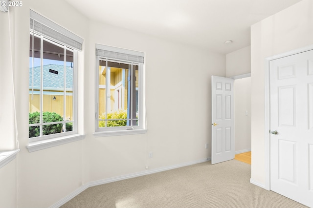 5274 NW Crady Ln, Portland, OR 97229 - unfurnished bedroom with multiple windows and light carpet