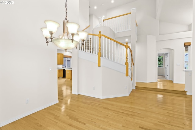 5274 NW Crady Ln, Portland, OR 97229 - entryway featuring a chandelier, high vaulted ceiling, light wood finished floors, arched walkways, and recessed lighting