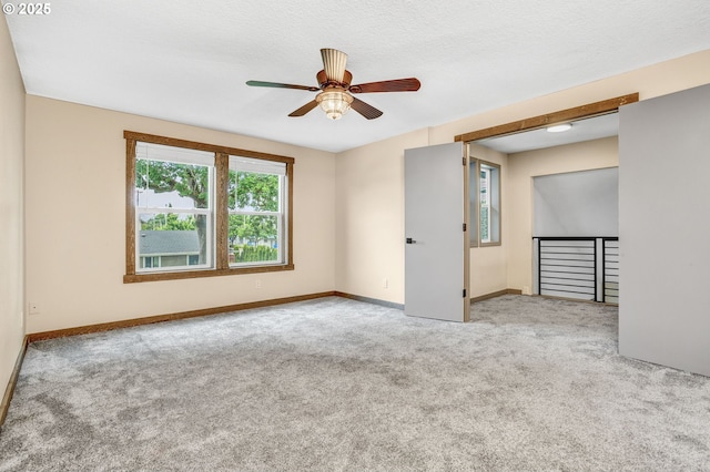 3017 SE Brookwood Ave, Hillsboro, OR 97123 - empty room featuring ceiling fan, carpet, and baseboards