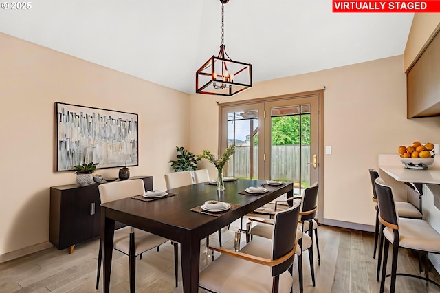 3017 SE Brookwood Ave, Hillsboro, OR 97123 - dining area with a chandelier, light wood-type flooring, baseboards, and vaulted ceiling