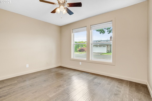 3017 SE Brookwood Ave, Hillsboro, OR 97123 - empty room with baseboards, ceiling fan, and light wood-style flooring