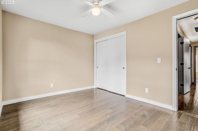 3017 SE Brookwood Ave, Hillsboro, OR 97123 - unfurnished bedroom featuring wood finished floors, baseboards, a closet, and ceiling fan