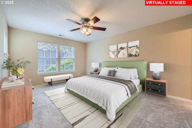 799 NE 70th Ave, Hillsboro, OR 97124 - carpeted bedroom featuring a textured ceiling, baseboards, and ceiling fan
