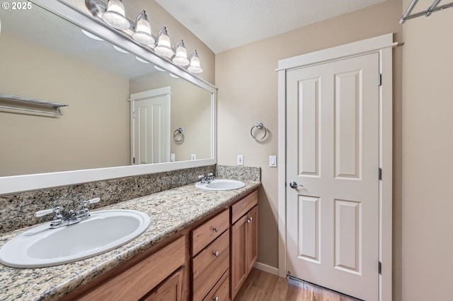 799 NE 70th Ave, Hillsboro, OR 97124 - bathroom with double vanity, wood finished floors, and baseboards