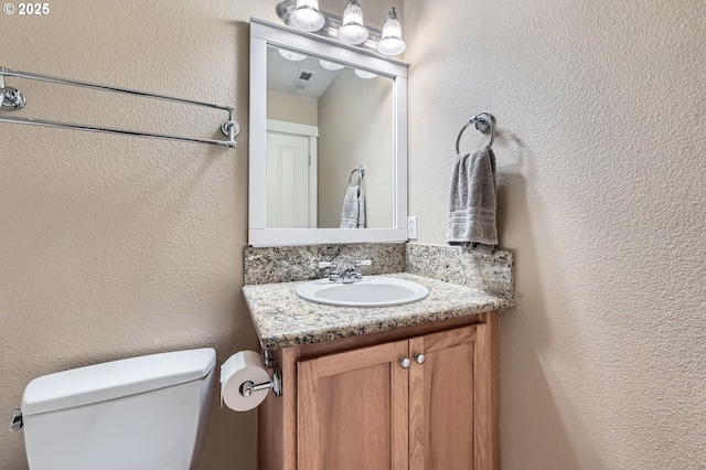 799 NE 70th Ave, Hillsboro, OR 97124 - bathroom featuring vanity, toilet, and a textured wall
