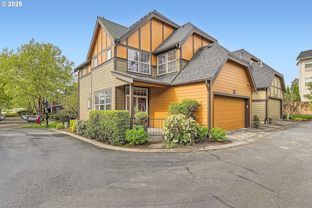 799 NE 70th Ave, Hillsboro, OR 97124 - view of front facade featuring an attached garage, roof with shingles, board and batten siding, and driveway