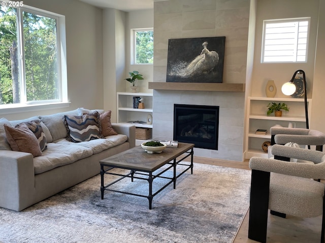 7839 SW Thornbridge Ter Unit 10, Beaverton, OR 97007 - living room with healthy amount of natural light, a tiled fireplace, and built in features