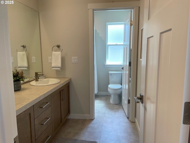 7839 SW Thornbridge Ter Unit 10, Beaverton, OR 97007 - full bathroom featuring vanity, toilet, baseboards, and tile patterned flooring