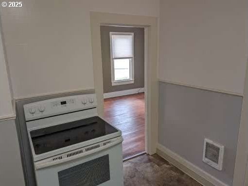315 W Marine Dr, Astoria, OR 97103 - kitchen with white range with electric cooktop and baseboards