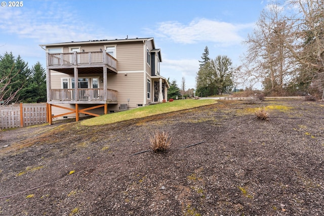 rear view of property featuring a balcony and central AC unit