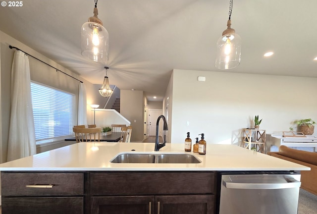 kitchen with pendant lighting, sink, dark brown cabinets, and stainless steel dishwasher