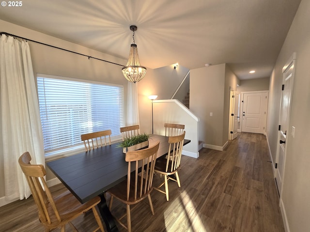 dining area with dark hardwood / wood-style floors and a chandelier