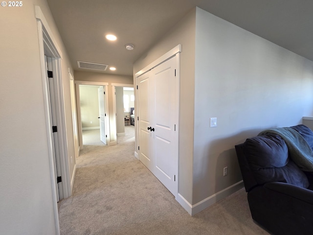 corridor with light colored carpet