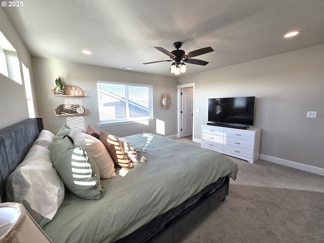 bedroom featuring multiple windows, light colored carpet, and ceiling fan