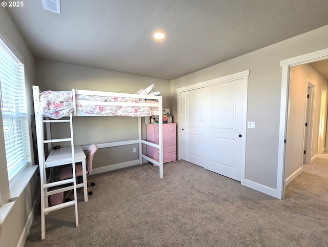 unfurnished bedroom featuring carpet floors and a closet