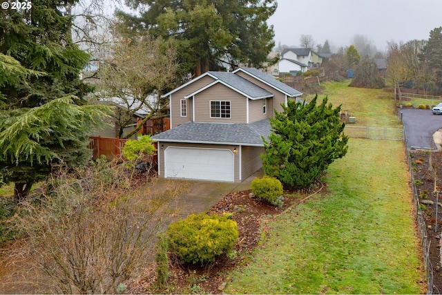 view of front of house with a garage and a front yard