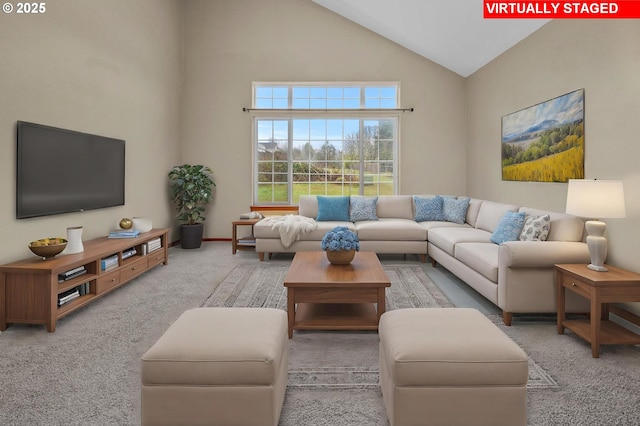 living room with a towering ceiling and light carpet