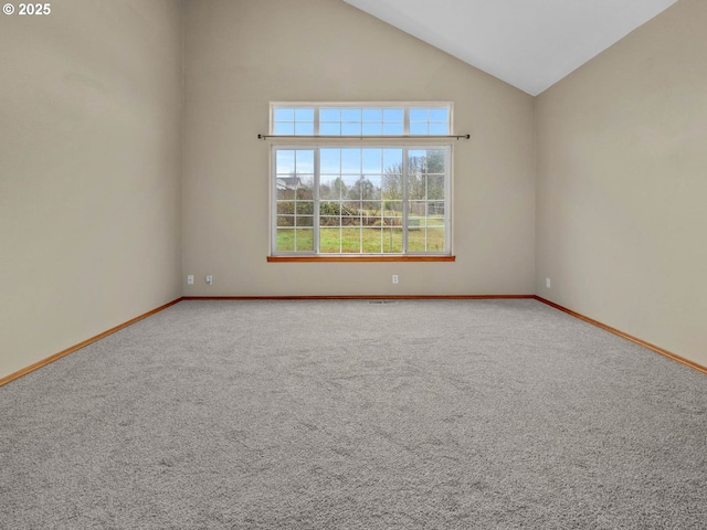 unfurnished room featuring high vaulted ceiling, baseboards, and carpet floors