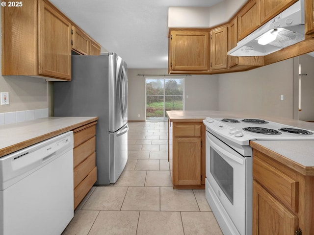 kitchen featuring light countertops, white appliances, light tile patterned flooring, and under cabinet range hood