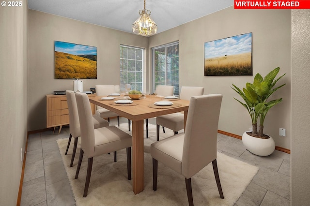 dining area with an inviting chandelier