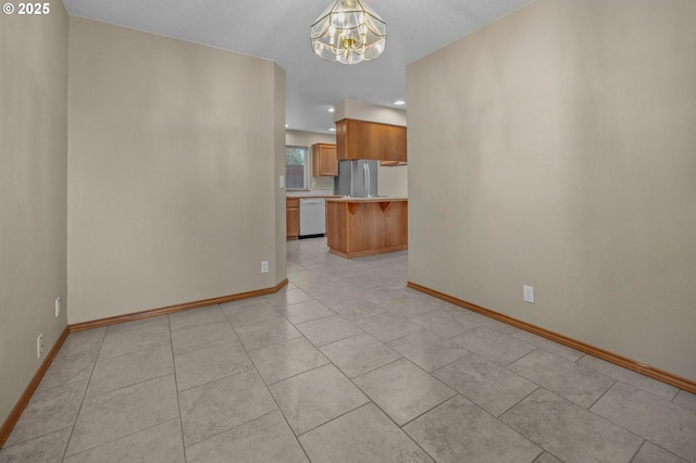 interior space featuring light tile patterned floors, baseboards, a notable chandelier, and recessed lighting