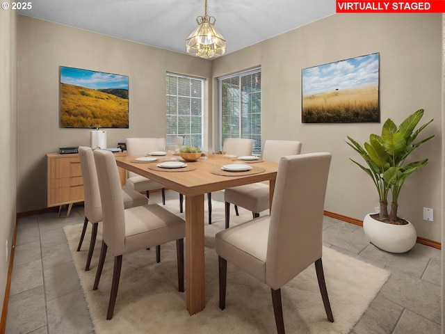 dining space with a notable chandelier and baseboards