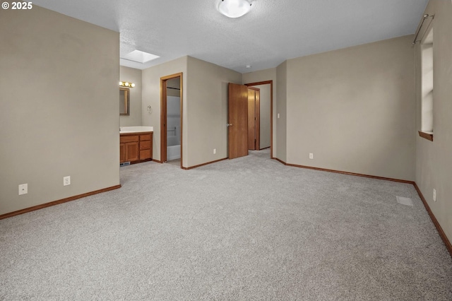 carpeted empty room with a skylight