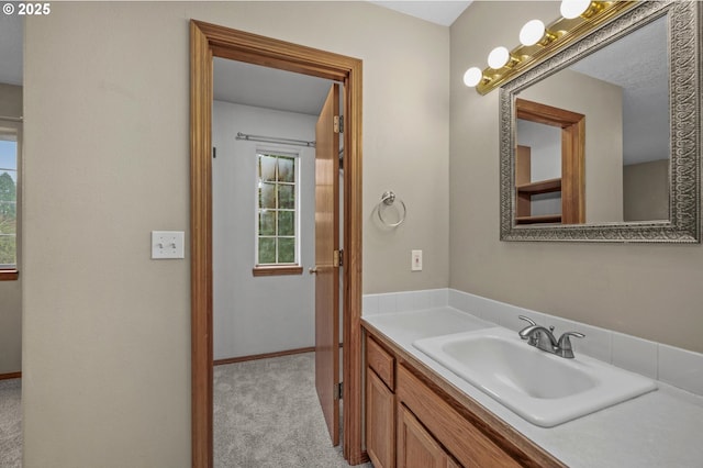 bathroom featuring baseboards and vanity