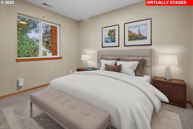 bedroom featuring light colored carpet, visible vents, and baseboards