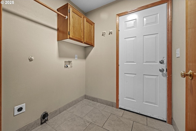 washroom with hookup for an electric dryer, cabinets, light tile patterned floors, and hookup for a washing machine