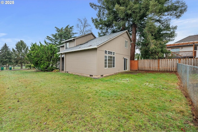 exterior space with crawl space, a lawn, and fence