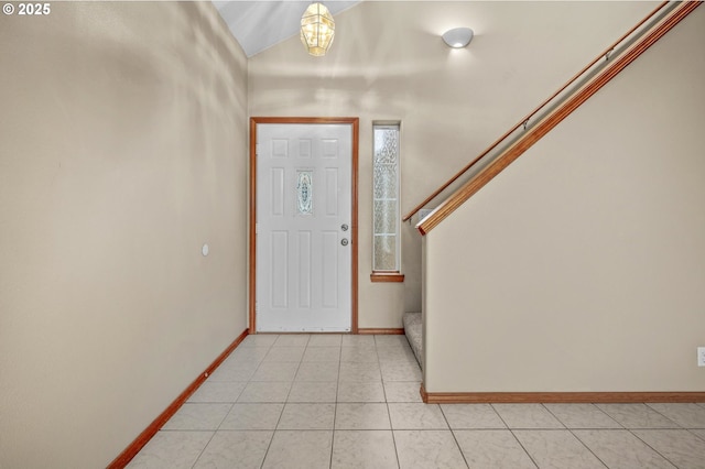 tiled entryway with lofted ceiling