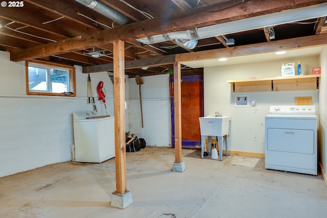 basement with a sink and washer and clothes dryer