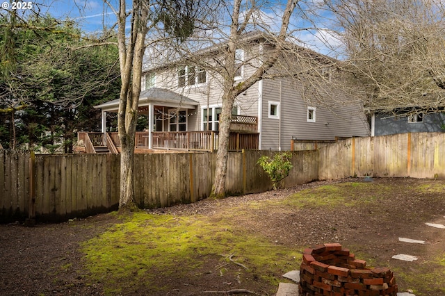 view of yard featuring a fenced backyard and a deck