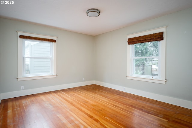 empty room featuring hardwood / wood-style floors and baseboards