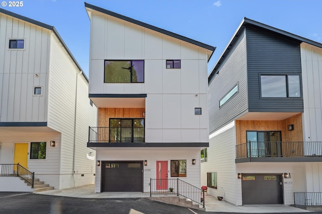10729 NE Fremont St, Portland, OR 97220 - view of front of home featuring a garage, a balcony, board and batten siding, and driveway