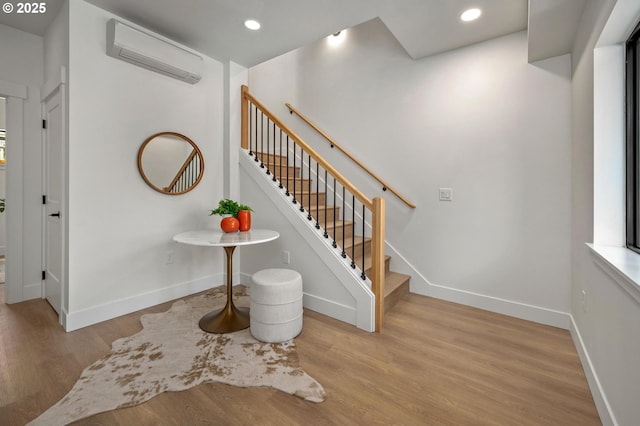 10729 NE Fremont St, Portland, OR 97220 - staircase featuring a wall mounted air conditioner, wood finished floors, baseboards, and recessed lighting