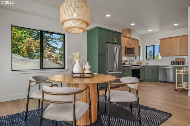 10729 NE Fremont St, Portland, OR 97220 - dining space with light wood-style flooring, healthy amount of natural light, recessed lighting, and baseboards