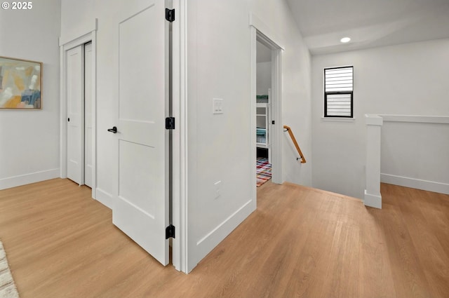 10729 NE Fremont St, Portland, OR 97220 - hall with an upstairs landing, light wood finished floors, baseboards, and recessed lighting