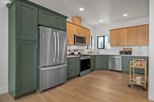 10729 NE Fremont St, Portland, OR 97220 - kitchen featuring green cabinetry, appliances with stainless steel finishes, a sink, and recessed lighting