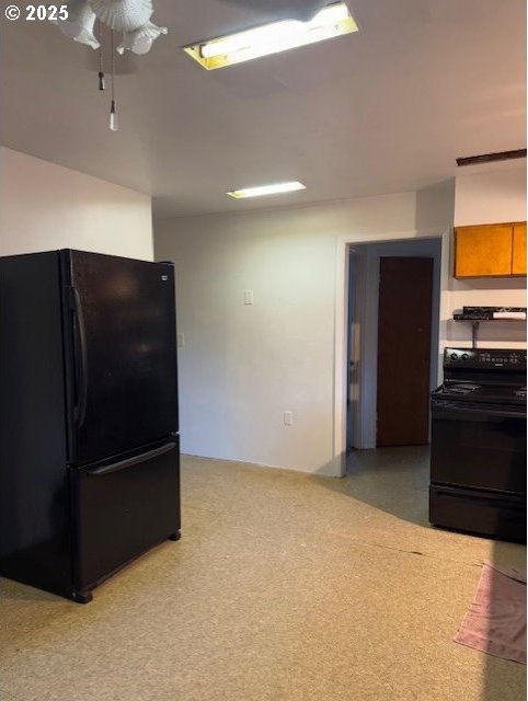 kitchen with ventilation hood and black appliances