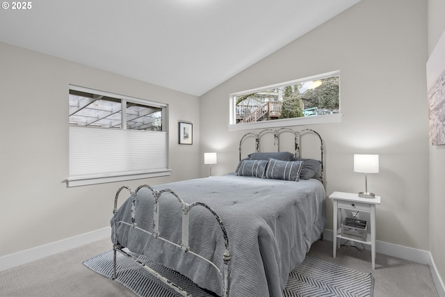 bedroom featuring lofted ceiling and light colored carpet