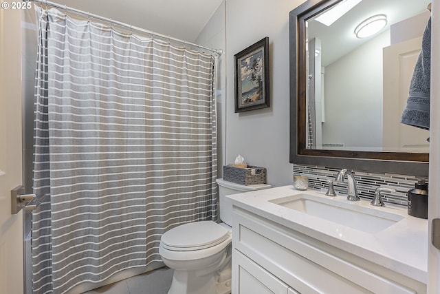 bathroom with backsplash, vanity, and toilet