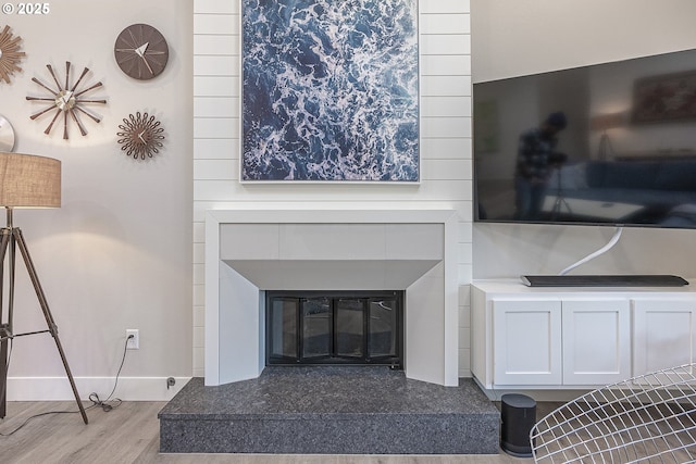 living room with a fireplace and hardwood / wood-style floors