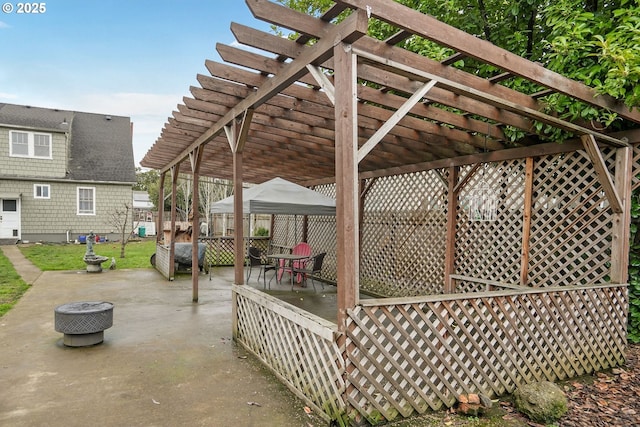 view of patio with an outdoor fire pit, fence, and a pergola