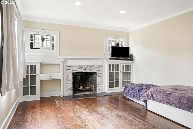 bedroom featuring ornamental molding, dark wood-style flooring, and multiple windows