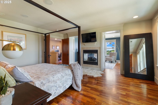 1046 NW Deerfern Loop, Camas, WA 98607 - bedroom with wood finished floors, a fireplace, and recessed lighting