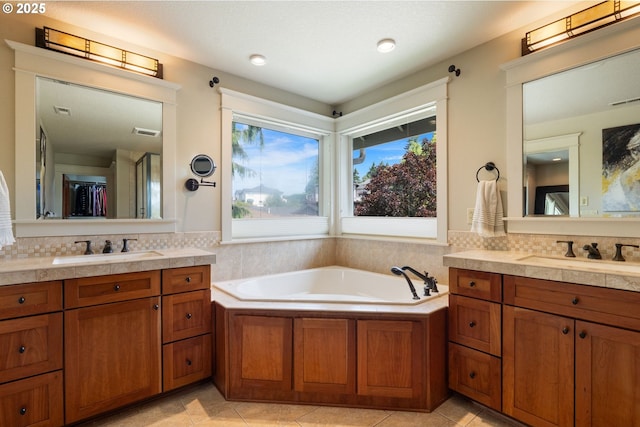 1046 NW Deerfern Loop, Camas, WA 98607 - bathroom with two vanities, a bath, tasteful backsplash, and tile patterned flooring