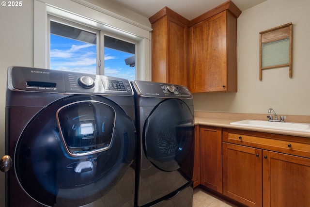 1046 NW Deerfern Loop, Camas, WA 98607 - laundry room featuring washer and clothes dryer, cabinet space, and light tile patterned flooring