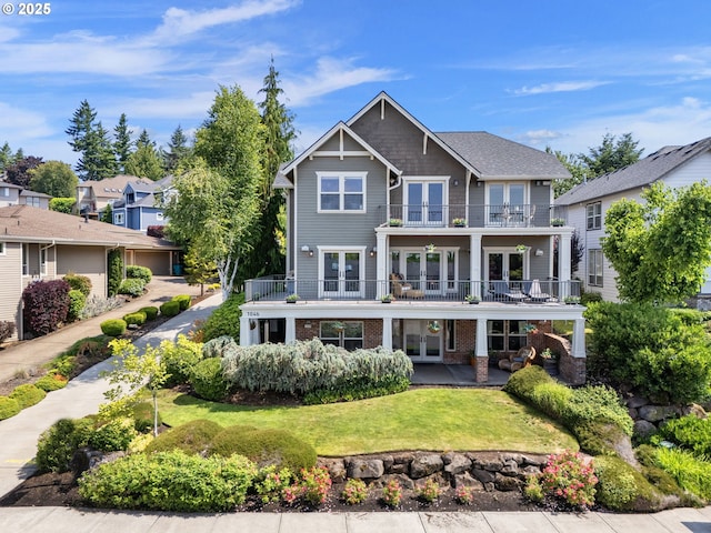 1046 NW Deerfern Loop, Camas, WA 98607 - back of house featuring french doors, a balcony, a lawn, brick siding, and a patio area